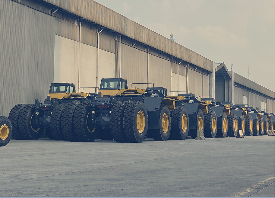 Lineup of Komatsu HD785 chassis prepared for export, symbolizing scale and efficiency